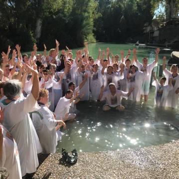 Group baptism at Yardenit, from the Yardenit Facebook page